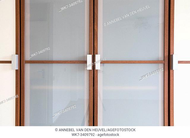 wooden white closet doors closeup for clothes modern new design with brown