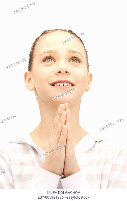 bright closeup portrait picture of praying teenage girl