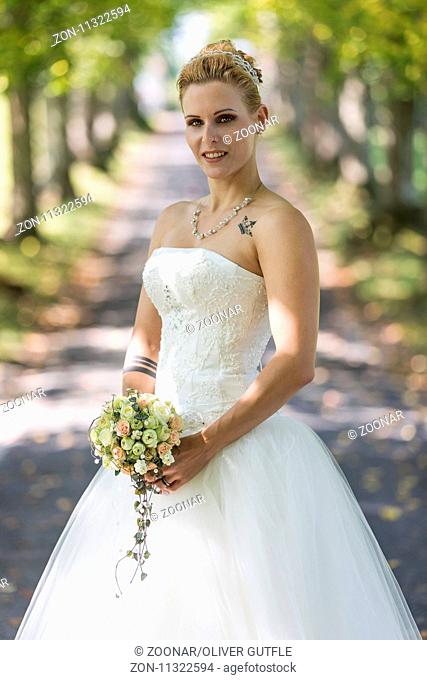 Young blond woman in the white wedding dress