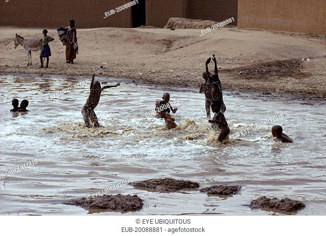 Tuareg children playing in rain pool