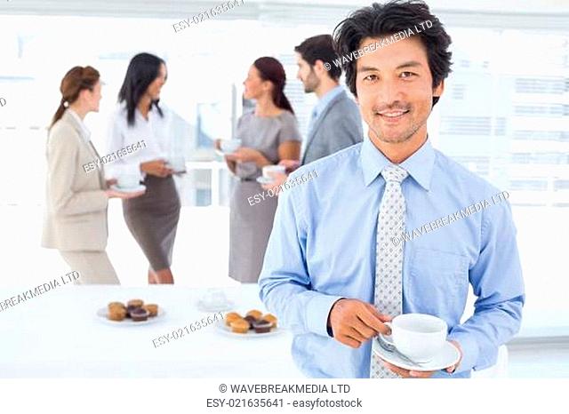 Smiling businessman with a drink