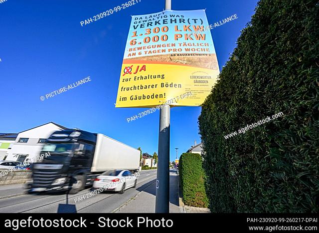 PRODUCTION - 15 September 2023, Bavaria, Straßkirchen: ""There's a lot of traffic going on - 1300 trucks, 6000 cars"" is written on a poster on a street in...
