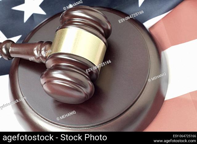 Justice mallet on United States flag in a courtroom during a judicial trial. Law concept and empty copy space. Judge hammer
