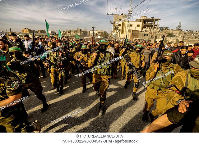 MemberS of Izz ad-Din al-Qassam Brigades, the military wing of the Hamas Islamist movement attend a funeral of a member of Palestinian security forces after he...