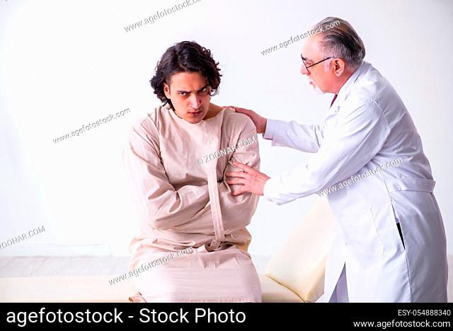 The aged male doctor psychiatrist examining young patient