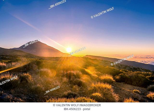 Sunset, sunset glow, cloudy sky, Volcano Teide and volcano landscape, backlit scenery, national park El Teide, Tenerife, Canary Islands, Spain