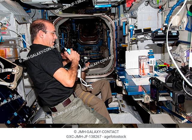 NASA astronaut Rick Mastracchio, Expedition 38 flight engineer, speaks in a microphone while conducting a session with the Capillary Flow Experiment (CFE-2) in...