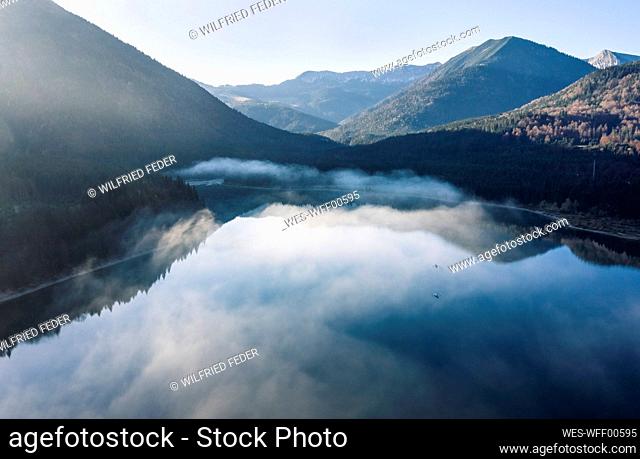 Beautiful view of Sylvenstein lake amidst mountains in foggy weather, Bad Tolz, Bavaria, Germany