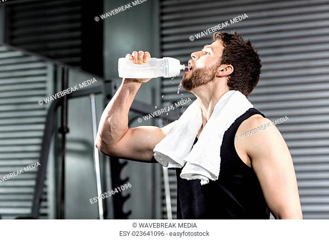 Fit man drinking water