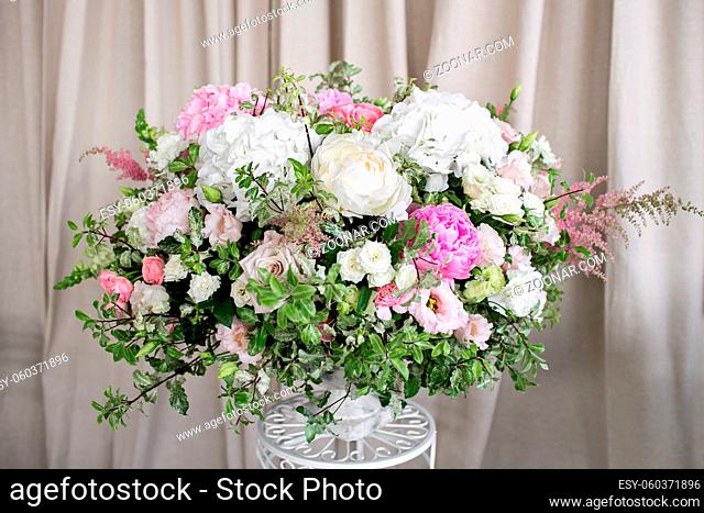 Arrange flowers in a white roman vase