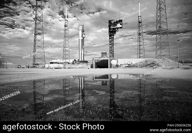 In this black and white infrared image, a United Launch Alliance Atlas V rocket with Boeing’s CST-100 Starliner spacecraft aboard is seen as it is rolled out of...