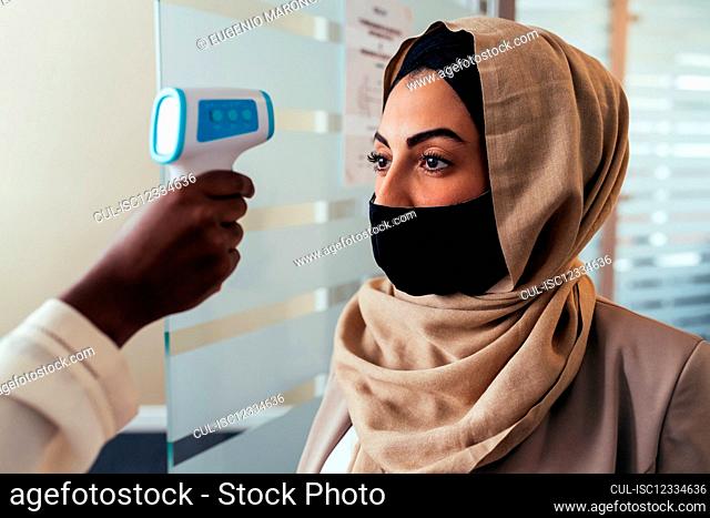 Woman having temperature check