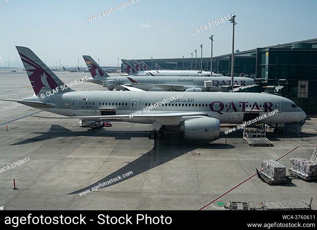 Doha, Qatar, Asia - Qatar Airways passenger planes at Hamad International Airport. Qatar Airways is a member of the One World airline alliance