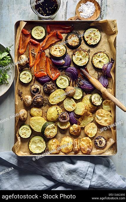 Roasted vegetables marinated with Teryaki sauce on a baking tray