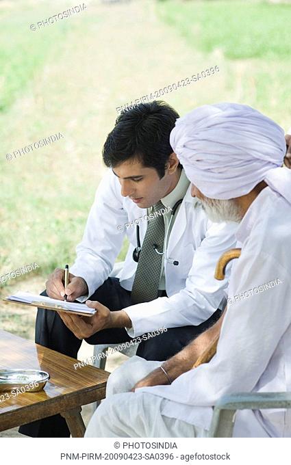 Doctor writing a prescription for a farmer