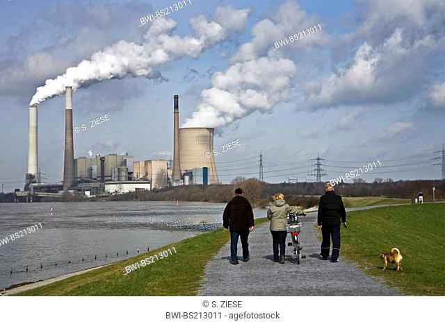 persons on a cycleway near Emscher estuary in the Rhine with Voerde power plant, Germany, North Rhine-Westphalia, Ruhr Area, Dinslaken