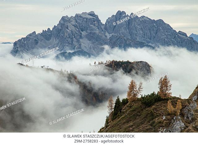 Misty autumn afternoon in Carnic Alps near Sappada, Belluno province, Veneto, Italy