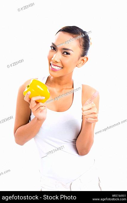 Young Asian woman living healthy and eating vegetables