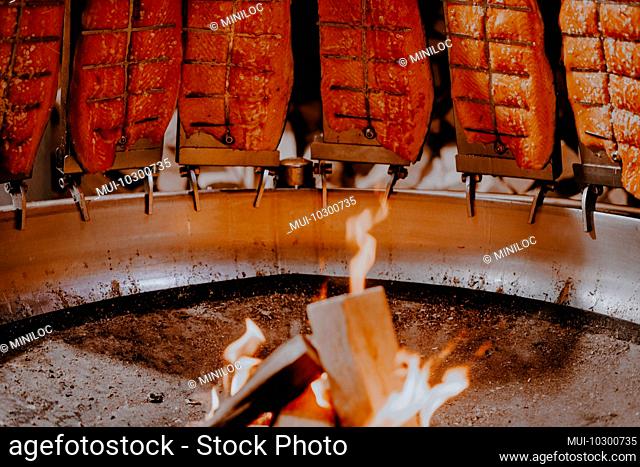 Salmon fish smoked on open fire at Christmas market in Hamburg, Germany
