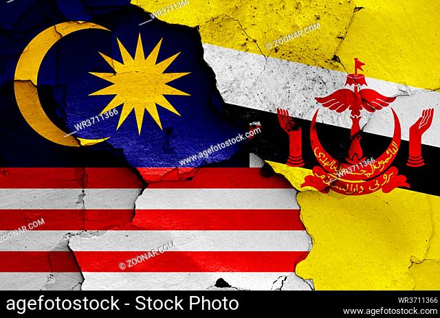 flags of Malaysia and Brunei painted on cracked wall