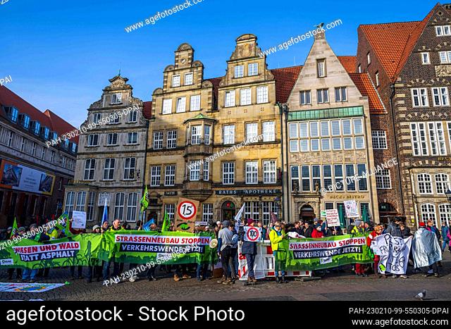 10 February 2023, Bremen: Activists demonstrate against transport policy and hold a banner reading ""Stop new road construction Transport turnaround now