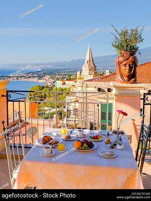 Taormina Sicily Italy breakfast table with a rooftop view over Taormina breakfast with coffee bread and fruit