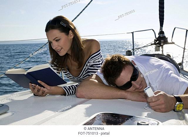 A couple relaxing on a yacht
