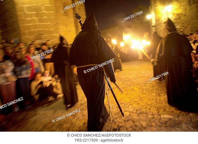 Penitents dressed as a Benedictine monks and holding torches participate at the procession of the Black Christ of Santa Maria during Easter Holy Week inside of...