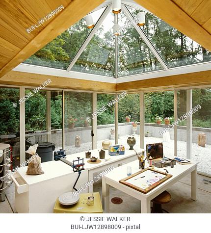 Cedar tongue and groove ceiling with glass sliding doors and skylights; view of courtyard