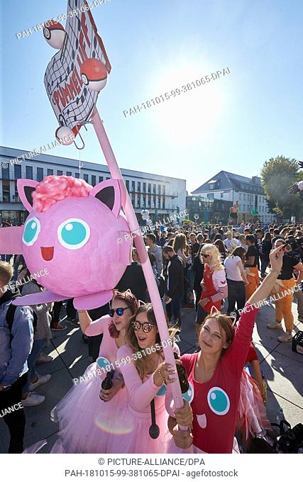 15 October 2018, Rhineland-Palatinate, Koblenz: Students in colourful Pokemon outfits welcome the freshmen who are celebrating their studies at the University...