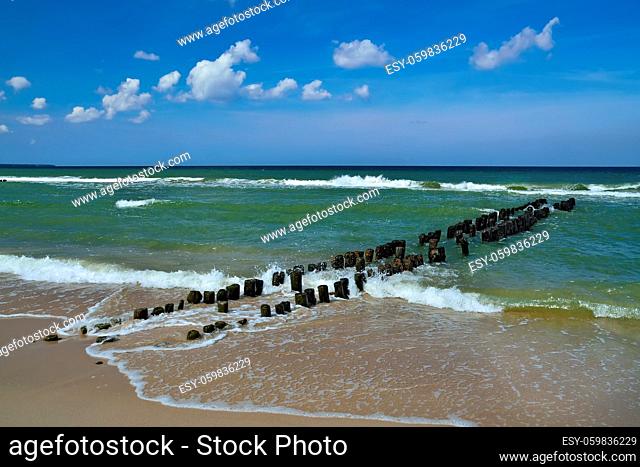 Breakwater on the beautiful sandy beach of the Baltic sea in sunny day