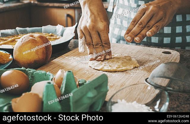 Close up of female working and cooking at home with fresh pasta making a handmade cake. Natural food lifestyle preparation concept