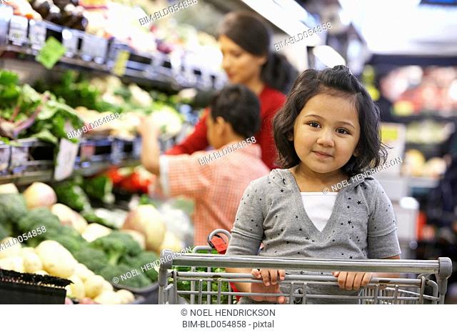 Indian girl sitting in shopping cart