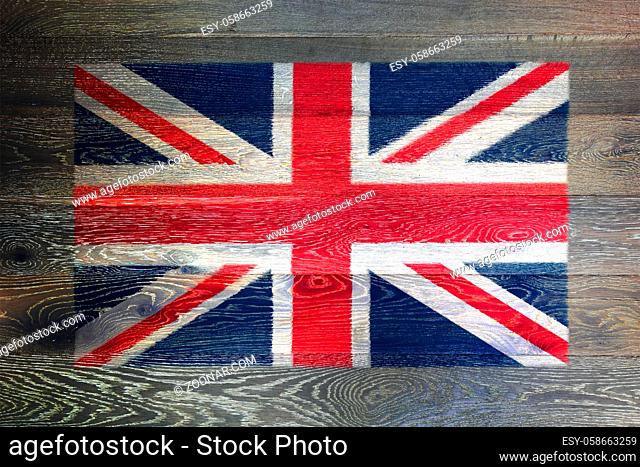 A United Kingdon of Great Britain flag on rustic old wood surface background union jack