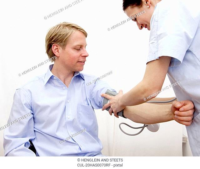 Doctor patient taking blood pressure