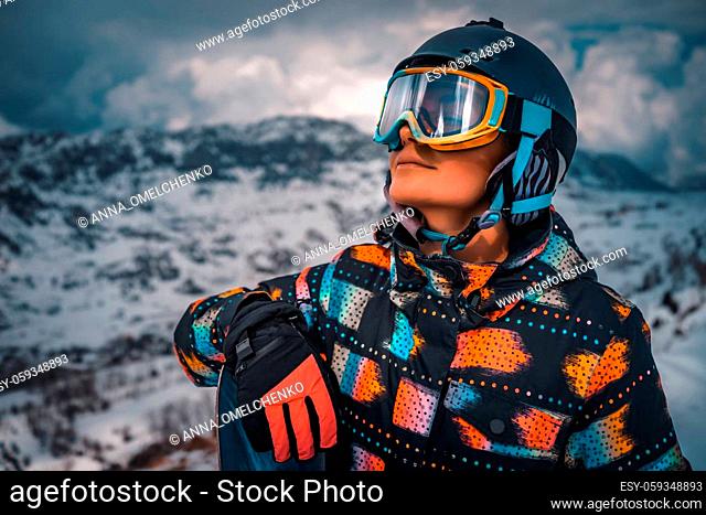 Snowboarder Preparing to Descend from the Mountain. Portrait of Happy Active Girl Enjoying Beautiful Winter Ski Resort