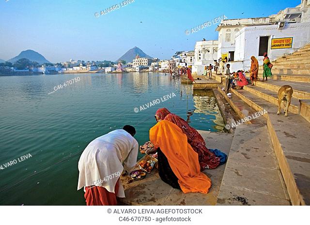 Pilgrims bathing in the Pushkar Holy lake during the Pushkar camel fair. Pushkar. Rajasthan. India. Asia