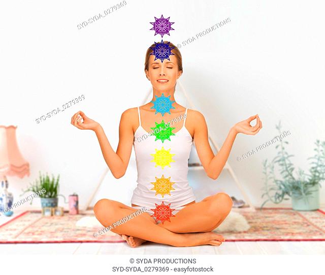 woman in lotus pose doing yoga with seven chakras