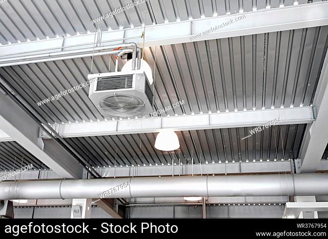 Industrial ventilation fan in factory interior ceiling