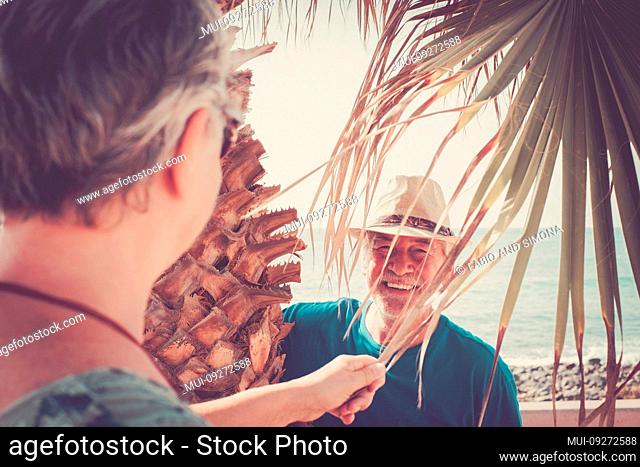 Old people senior caucasian couple man and woman playing and having fun together in outdoor leisure activity - happy retired youthful concept with cheerful male...
