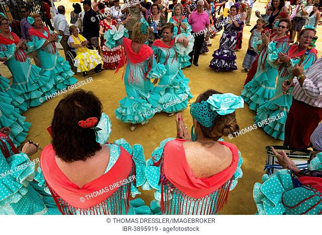 Women wearing gypsy dresses perform traditional Andalusian dances at the Feria del Caballo, Jerez de la Frontera, Cádiz province, Andalusia, Spain