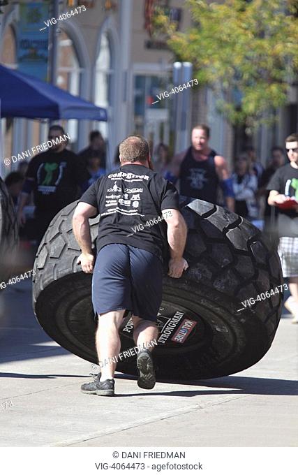 CANADA, KITCHENER, A contestant strains to lift an 850 pound (385 kilogram) tire during a strongman competition in Kitchener, Ontario, Canada