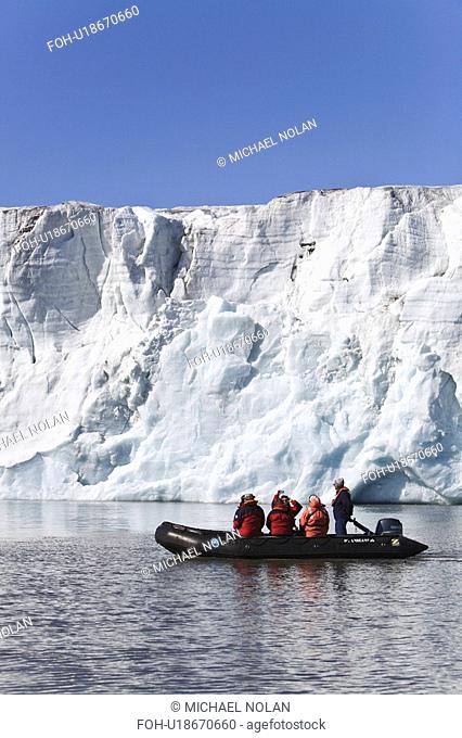 Zodiac cruisers get a view of the tidewater glacier in Isbukta Ice Bay on the western side of Spitsbergen Island in the Svalbard Archipelago, Barents Sea