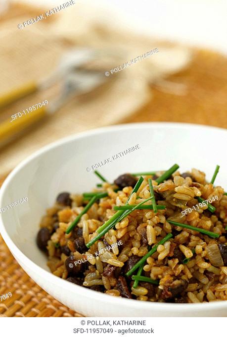 A bowl of natural rice with black beans and chives