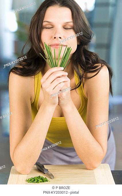 Woman smelling chives