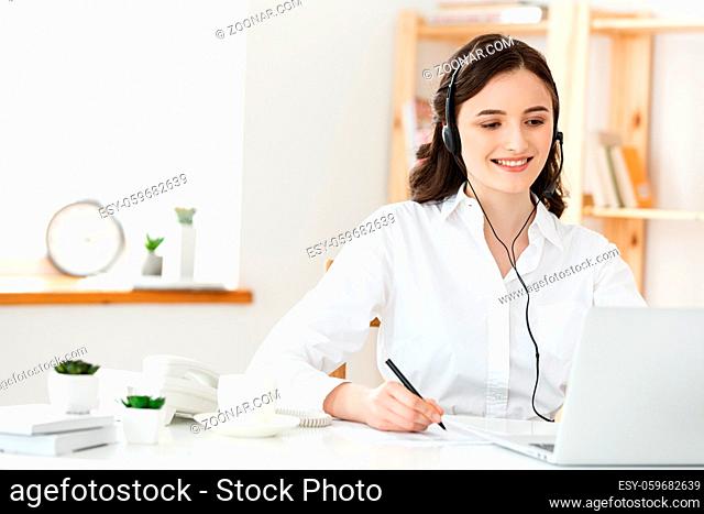 Call Center Concept: Portrait of happy smiling female customer support phone operator at workplace