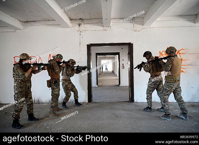 special forces soldiers team in urban environment making tactical assault action