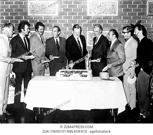 Jan. 1, 1969 - Hollywood, CA, U.S. - Iconic, Academy Award winning, JOHN WAYNE surrounded by his colleagues cutting the birthday cake during the celebration of...