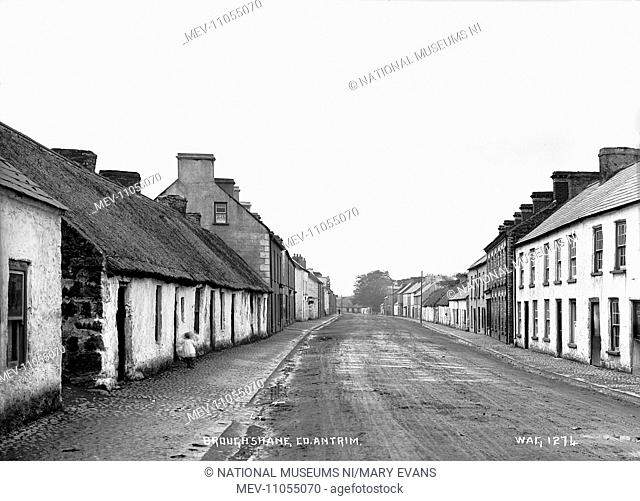 Broughshane, Co. Antrim - a view of the main street with a thatched cottage to the left. (Location: Northern Ireland: County Antrim: Broughshane)