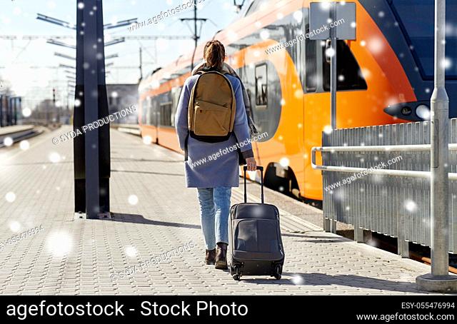 woman with travel bag on railway station